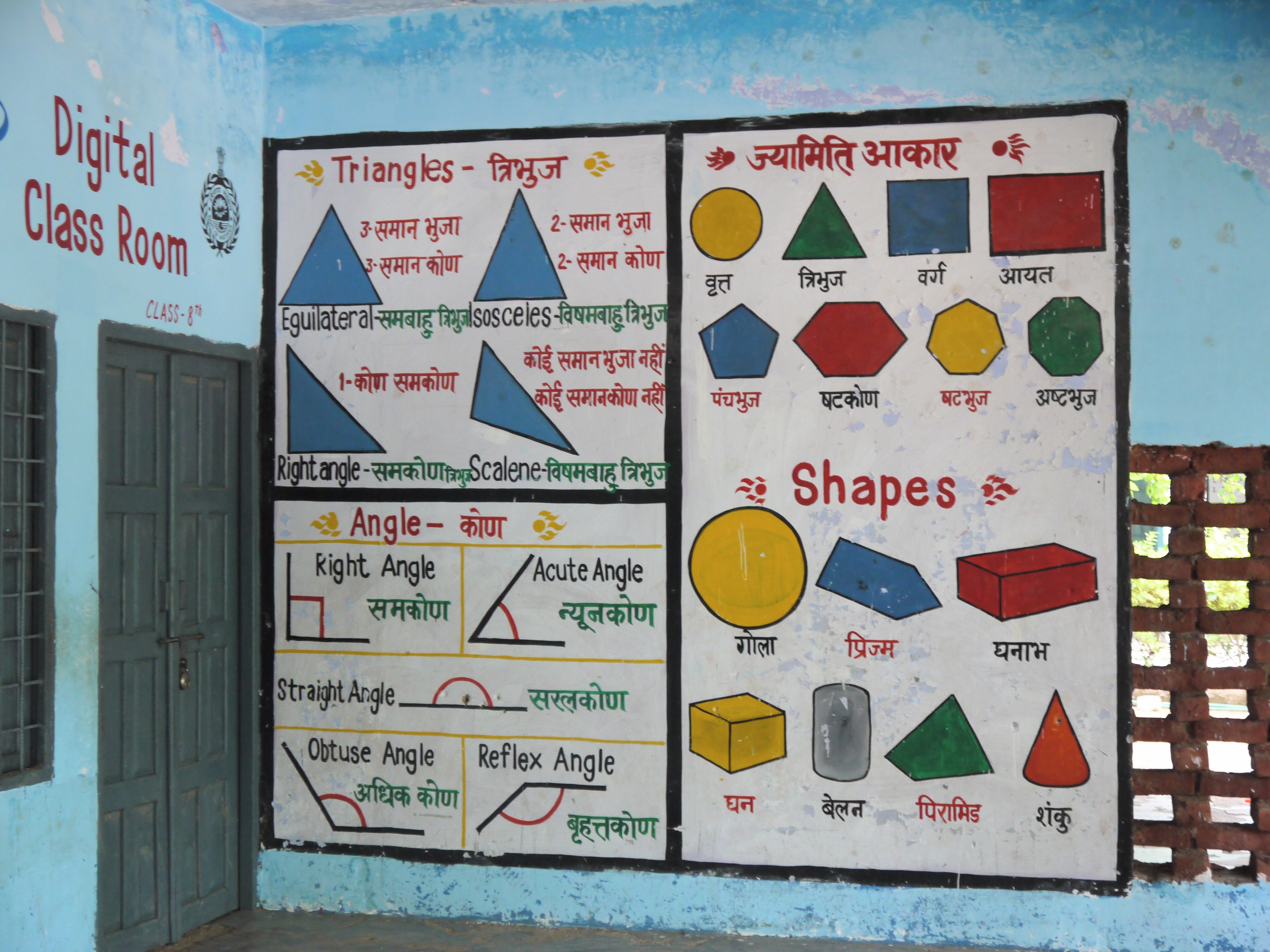 A geometry mural in Hindi and English showing the types of angles and triangles, and the names of shapes and figures.